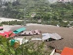 Residential buildings partially submerged in sludge in Uttarkashi. (AFP) Residential buildings partially submerged in sludge in Uttarkashi. (AFP)