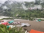Residential buildings partially submerged in sludge after a cloudburst caused a massive mudslide in India's Uttarakhand state.
