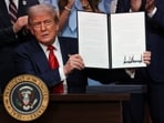 US President Donald Trump holds up an executive order at the White House in Washington, DC, on August 5, 2025. 