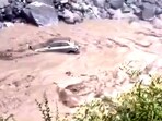 A chilling video shows a car being swept away by floodwaters in Uttarakhand A chilling video shows a car being swept away by floodwaters in Uttarakhand