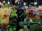 A fruit and vegetable vendor waits for customers in Tajrish traditional bazaar in northern Tehran, Iran, Monday, June 2