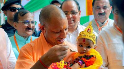 Chief minister Yogi Adityanath feeds a child during an event in Moradabad on Wednesday. (PTI PHOTO) Chief minister Yogi Adityanath feeds a child during an event in Moradabad on Wednesday. (PTI PHOTO)