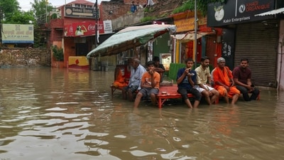 At Assi Ghat, river water overflowed onto the road and reached near the gate of the Jagannath Temple. As more people gathered to watch, police put up barricades to keep the area safe. (AFP) At Assi Ghat, river water overflowed onto the road and reached near the gate of the Jagannath Temple. As more people gathered to watch, police put up barricades to keep the area safe. (AFP)
