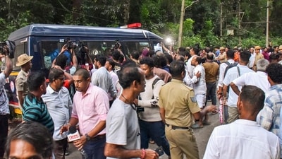 People gather near a site of an alleged burial related to the Dharmasthala mass burial case, at Dharmasthala, in Dakshina Kannada district. (PTI File) People gather near a site of an alleged burial related to the Dharmasthala mass burial case, at Dharmasthala, in Dakshina Kannada district. (PTI File)