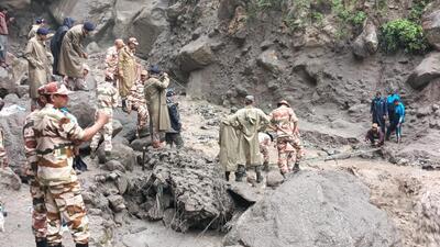 Personnel of the 17th Battalion of the Indo-Tibetan Border Police (ITBP) rescuing pilgrims on Wednesday after a bridge on the Kangrang Nullah was washed away due to a flash flood on the Kinnaur-Kailash Yatra route in Kinnaur district. (HT Photo)