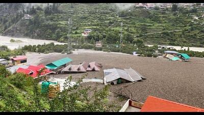 Residential buildings partially submerged in sludge in Uttarkashi. (AFP) Residential buildings partially submerged in sludge in Uttarkashi. (AFP)