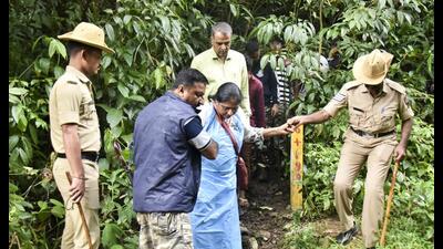 Security personnel near a site of an alleged burial related to the Dharmasthala mass burial case, at Dharmasthala, in Dakshina Kannada district on Wednesday. (PTI PHOTO) Security personnel near a site of an alleged burial related to the Dharmasthala mass burial case, at Dharmasthala, in Dakshina Kannada district on Wednesday. (PTI PHOTO)