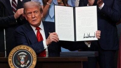 US President Donald Trump holds up an executive order at the White House in Washington, DC, on August 5, 2025. (REUTERS)
