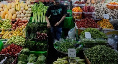A fruit and vegetable vendor waits for customers in Tajrish traditional bazaar in northern Tehran, Iran, Monday, June 2 (AP FILE) A fruit and vegetable vendor waits for customers in Tajrish traditional bazaar in northern Tehran, Iran, Monday, June 2 (AP FILE)