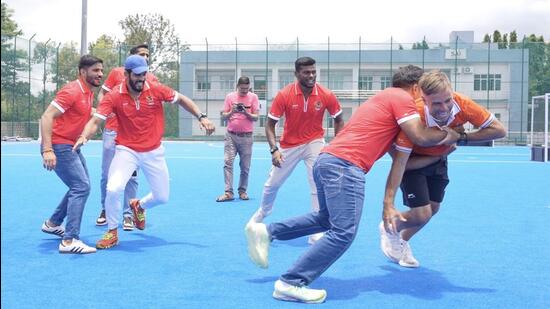 Indian men’s hockey team chief coach Craig Fulton tries his hand at raiding as his side met members of PKL team Gujarat Giants in Bengaluru on Wednesday. (HT)