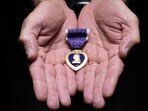 Retired Sgt. Maj. James K. Bodecker shows his Purple Heart, awarded after he was shot by a sniper in Ramadi, Iraq, on Feb. 17, 2006. Retired Sgt. Maj. James K. Bodecker shows his Purple Heart, awarded after he was shot by a sniper in Ramadi, Iraq, on Feb. 17, 2006.