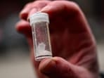 A police officer holds a vial of meth found in downtown Portland, Oregon, Jan. 25, 2024.