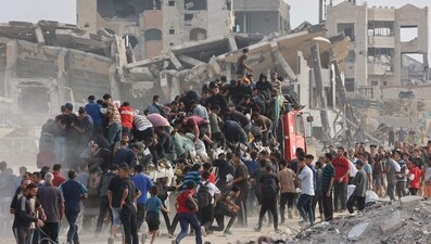 People rush towards an truck carrying humanitarian aid as it drives along al-Rashid street in western Jabalia (AFP) People rush towards an truck carrying humanitarian aid as it drives along al-Rashid street in western Jabalia (AFP)