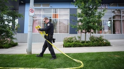 A police officer takes down crime scene tape outside Kapil Sharma's cafe that was shot at multiple times, in Surrey, British Columbia. (AP) A police officer takes down crime scene tape outside Kapil Sharma's cafe that was shot at multiple times, in Surrey, British Columbia. (AP)