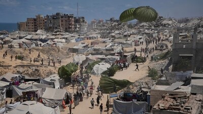 Palestinians rush to collect humanitarian aid airdropped by parachutes into Gaza City, northern Gaza Strip. (AP) Palestinians rush to collect humanitarian aid airdropped by parachutes into Gaza City, northern Gaza Strip. (AP)