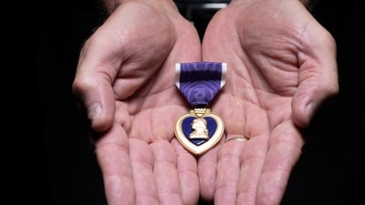 Retired Sgt. Maj. James K. Bodecker shows his Purple Heart, awarded after he was shot by a sniper in Ramadi, Iraq, on Feb. 17, 2006. (U.S. Department of Defense) Retired Sgt. Maj. James K. Bodecker shows his Purple Heart, awarded after he was shot by a sniper in Ramadi, Iraq, on Feb. 17, 2006. (U.S. Department of Defense)