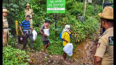 Workers leave from a site of an alleged burial related to the Dharmasthala mass burial case, at Dharmasthala, in Dakshina Kannada district. (PTI PHOTO) Workers leave from a site of an alleged burial related to the Dharmasthala mass burial case, at Dharmasthala, in Dakshina Kannada district. (PTI PHOTO)