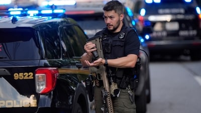 An armed Police officer prepares near the scene of shooting at the Emory University in Atlanta on Friday, Aug. 8, 2025. (AP Photo/Mike Stewart) (AP) An armed Police officer prepares near the scene of shooting at the Emory University in Atlanta on Friday, Aug. 8, 2025. (AP Photo/Mike Stewart) (AP)