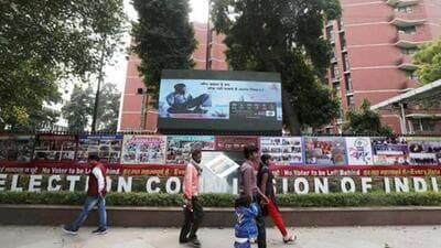 People walk past the Election Commission of India office building in New Delhi. (REUTERS) People walk past the Election Commission of India office building in New Delhi. (REUTERS)