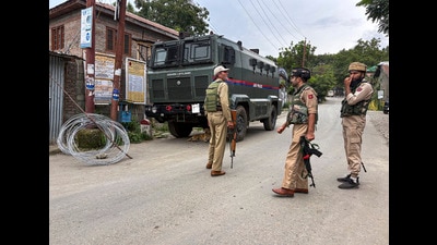 Police personnel keep a vigil amid an ongoing encounter between security forces and terrorists at a forest area, in Kulgam district, Jammu and Kashmir, on Friday. (PTI)
