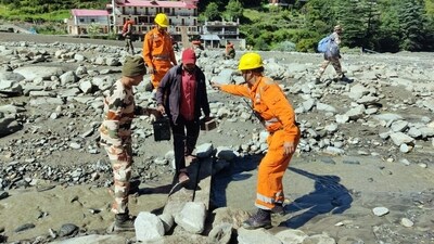 SDRF and ITBP personnel rescue citizens to ITBP Matli, who were stranded due to the devastating floods that hit Uttarkashi. (Virender Negi/ANI) SDRF and ITBP personnel rescue citizens to ITBP Matli, who were stranded due to the devastating floods that hit Uttarkashi. (Virender Negi/ANI)
