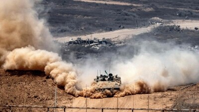 An Israeli army infantry-fighting vehicle (IFV) leaves a cloud of dust as it moves at a position along Israel's southern border with the Gaza Strip. (AFP) An Israeli army infantry-fighting vehicle (IFV) leaves a cloud of dust as it moves at a position along Israel's southern border with the Gaza Strip. (AFP)