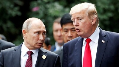 President Donald Trump and Russia's President Vladimir Putin talk during the family photo session at the APEC Summit in Danang (REUTERS)