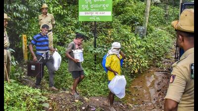 Workers leave from a site of an alleged burial related to the Dharmasthala mass burial case, at Dharmasthala, in Dakshina Kannada district. (PTI PHOTO) Workers leave from a site of an alleged burial related to the Dharmasthala mass burial case, at Dharmasthala, in Dakshina Kannada district. (PTI PHOTO)