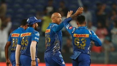 Tymal Mills (centre) celebrates with MI players Tymal Mills (centre) celebrates with MI players