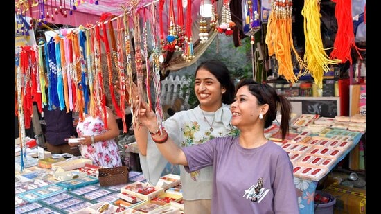 Girls buying rakhi at a shop in Jawahar Nagar Camp in Ludhiana on Friday. (HT Photo)