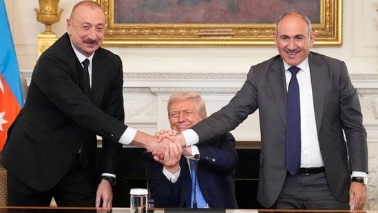 Donald Trump, center, shakes hands with Armenian Prime Minister Nikol Pashinyan, right, and Azerbaijan President Ilham Aliyev. (AP)