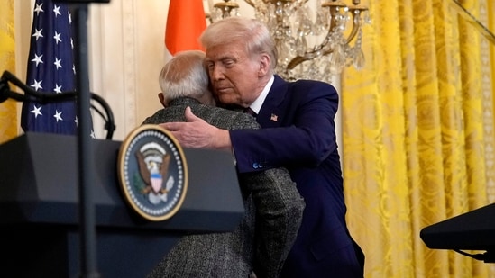 US President Donald Trump, right, hugs Prime Minister Narendra Modi during a news conference at the White House (AP)