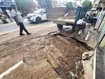 A civic body worker conducting repair work at the cave-in site on Pakhowal road in Ludhiana on Saturday. (Gurpreet Singh/HT) A civic body worker conducting repair work at the cave-in site on Pakhowal road in Ludhiana on Saturday. (Gurpreet Singh/HT)