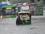 A man pushes his autorickshaw through a waterlogged stretch of Rohtak Road near Anand Parbat, Delhi, on Saturday. (Sanchit Khanna/HT)