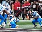 Detroit Lions safety Morice Norris (26) is hit in the helmet by Atlanta Falcons running back Nathan Carter (38) during the second half of an NFL preseason football game Friday, Aug. 8, 2025, in Atlanta. (AP Photo/Brynn Anderson)