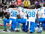 Detroit Lions and Atlanta Falcons players take a knee as Detroit Lions safety Morice Norris is helped by medical personnel on the field during the second half of an NFL preseason football game Friday, Aug. 8, 2025, in Atlanta. (AP Photo/Brynn Anderson)