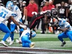 Detroit Lions safety Morice Norris (26) is hit in the helmet by Atlanta Falcons running back Nathan Carter (38) during the second half of an NFL preseason football game Friday, Aug. 8, 2025, in Atlanta. (AP Photo/Brynn Anderson)