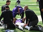 Minnesota Vikings wide receiver Rondale Moore (4) is attended to by head coach Kevin O'Connell 