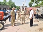 The police team at Gaosian Khan Muhammad village, where the encounter took place, on Friday. (HT Photo) The police team at Gaosian Khan Muhammad village, where the encounter took place, on Friday. (HT Photo)