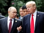 US President Donald Trump and Russia's President Vladimir Putin talk during the family photo session at the APEC Summit in Danang, Vietnam, November 11, 2017.
