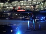 Police officers stand as they block off a road at Emory University Hospital