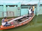 A man rides a boat with others in an area inundated with the swollen Ganga river water, amid monsoon season, in Varanasi, Uttar Pradesh, Saturday, Aug. 9, 2025. A man rides a boat with others in an area inundated with the swollen Ganga river water, amid monsoon season, in Varanasi, Uttar Pradesh, Saturday, Aug. 9, 2025.