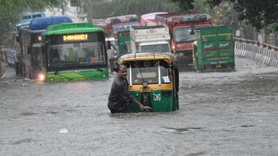 A man pushes his autorickshaw through a waterlogged stretch of Rohtak Road near Anand Parbat, Delhi, on Saturday. (Sanchit Khanna/HT) A man pushes his autorickshaw through a waterlogged stretch of Rohtak Road near Anand Parbat, Delhi, on Saturday. (Sanchit Khanna/HT)