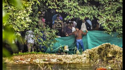 ASpecial Investigation Team (SIT) examining the site in the Dharmasthala mass burial case in Dakshina Kannada district of Karnataka. (PTI PHOTO)