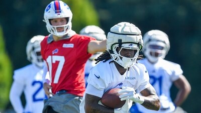 Buffalo Bills running back James Cook (4) takes a handoff from quarterback Josh Allen (17) during practice (AP) Buffalo Bills running back James Cook (4) takes a handoff from quarterback Josh Allen (17) during practice (AP)