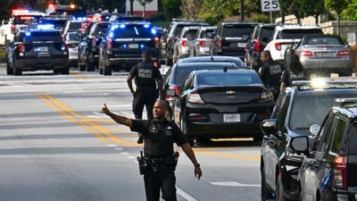Police officers block Clifton Road near Emory Hospital as they respond to a shooting near the campuses of the U.S. Centers for Disease Control and Prevention and Emory University, Friday, Aug. 8, 2025, in (Hyosub Shin/Atlanta Journal-Constitution via AP) (AP)