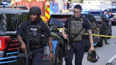 Armed police officers walk near the scene of shooting at the Emory University in Atlanta on Friday (AP) Armed police officers walk near the scene of shooting at the Emory University in Atlanta on Friday (AP)