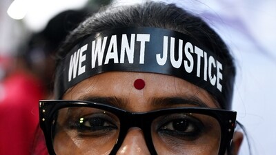 A protestor wears a headband that reads, ‘We want justice’, as she takes part in a rally on the eve of the first death anniversary of the rape-murder victim doctor of the state-run RG Kar Medical College and Hospital, in Kolkata. (PTI)