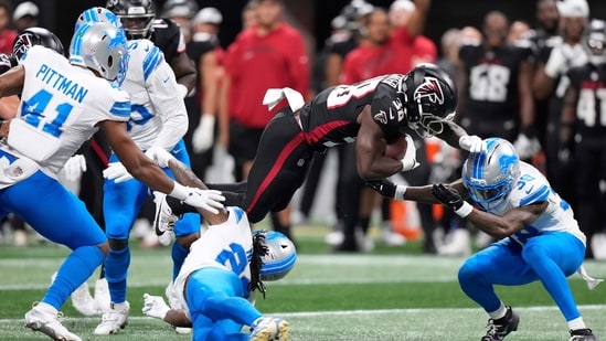 Detroit Lions safety Morice Norris (26) is hit in the helmet by Atlanta Falcons running back Nathan Carter (38) during the second half of an NFL preseason football game Friday, Aug. 8, 2025, in Atlanta. (AP Photo/Brynn Anderson) (AP)