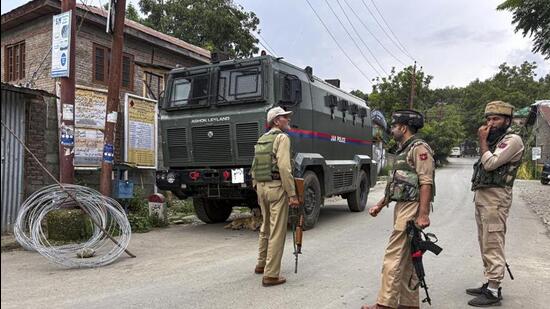 Police personnel keeping a vigil amid an ongoing encounter between security forces and terrorists in the Akhal forest in Kulgam district of Jammu and Kashmir. (PTI Photo)